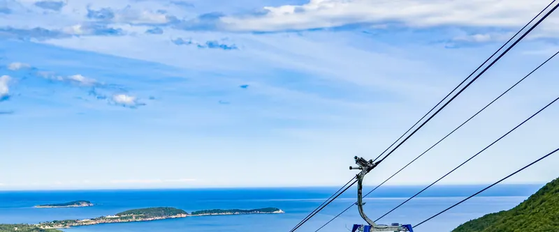 Atlantic Gondola cabin above green forest with the ocean bay beyond
