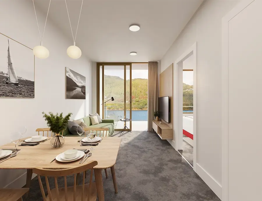 Living and dining room with a set table, a sofa and a terrace door with lake views