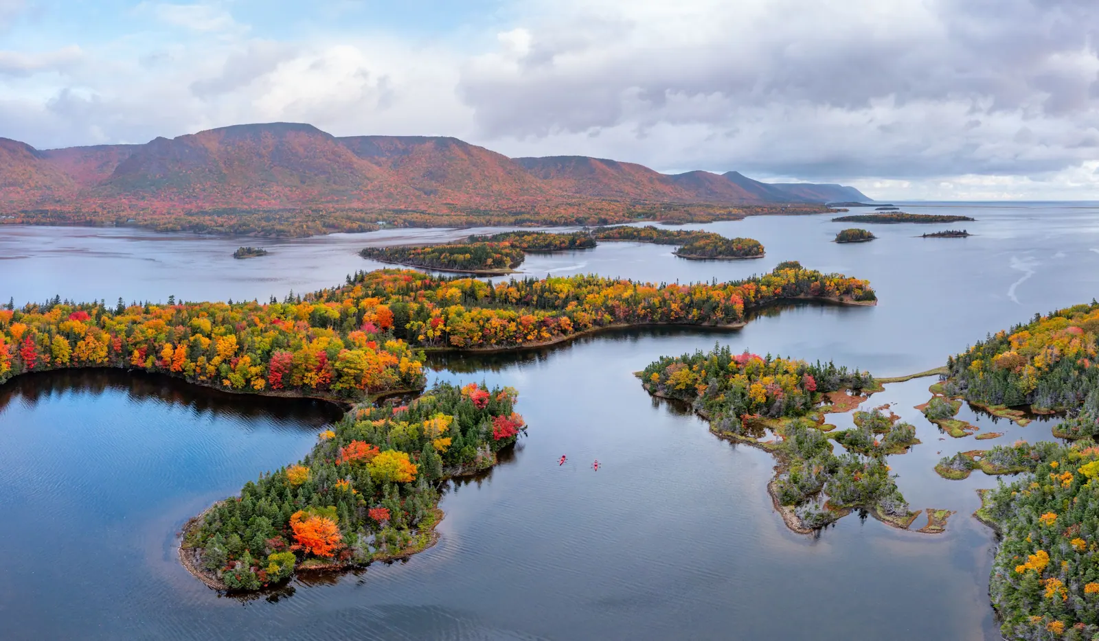 Autumn forest on islands in a calm bay below the Cape Breton highlands