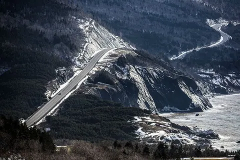 The Cabot Trail winding along snowy mountain cliffs