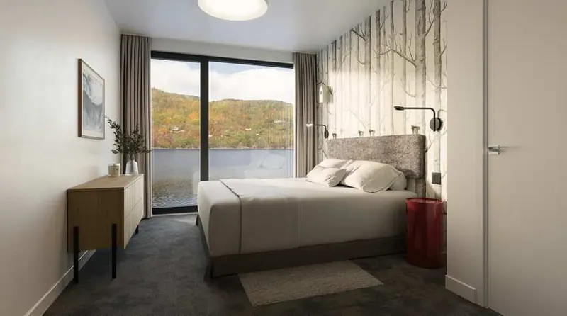 Bedroom with a birch-forest feature wall and a view of the lake