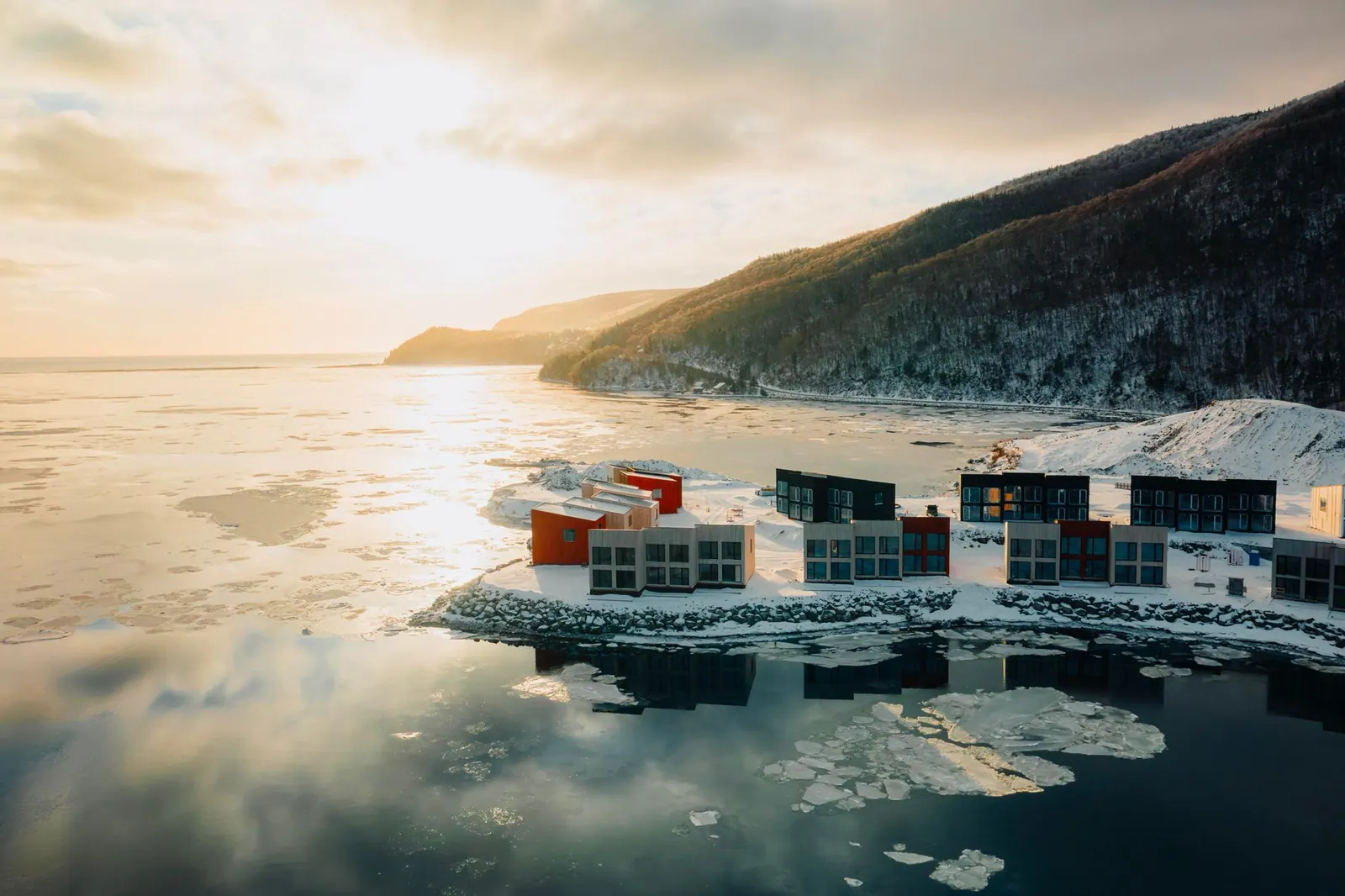Cormorant Rock chalets on the snowy shore below Cape Smokey