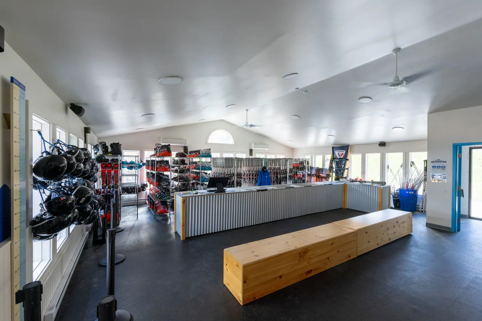 Inside the Cape Smokey rental shop with racks of skis, boots and helmets