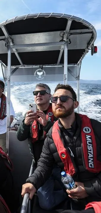 Passengers in life jackets on a fast tour boat out on the ocean