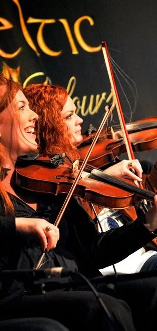 Fiddlers and musicians performing on stage at the Celtic Colours festival
