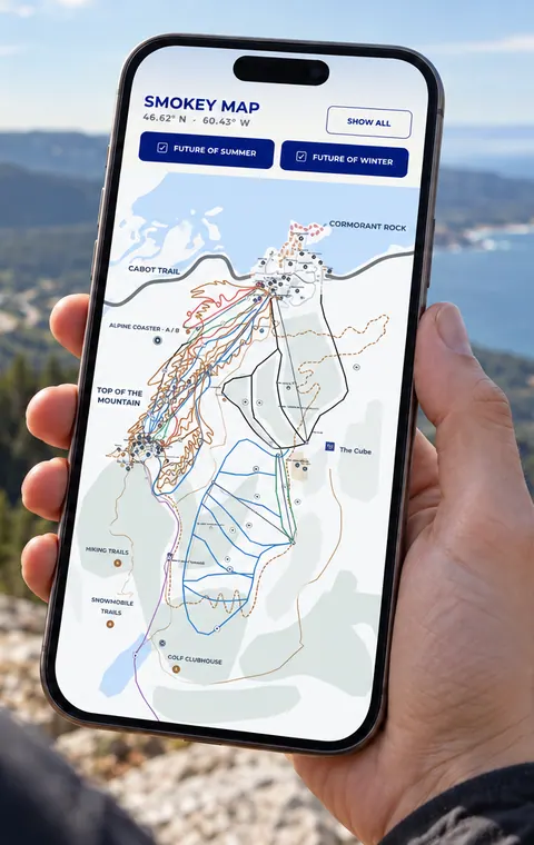 Hand holding a phone with the Smokey Map app above the Cape Breton coastline