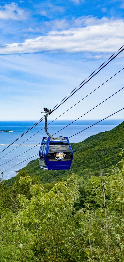 Atlantic Gondola cabin above the green hillside and the ocean