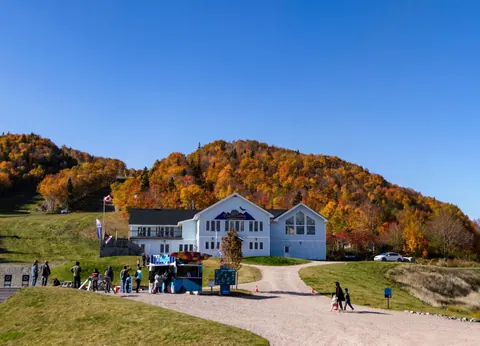 The Cape lodge at the base of Cape Smokey surrounded by autumn colours