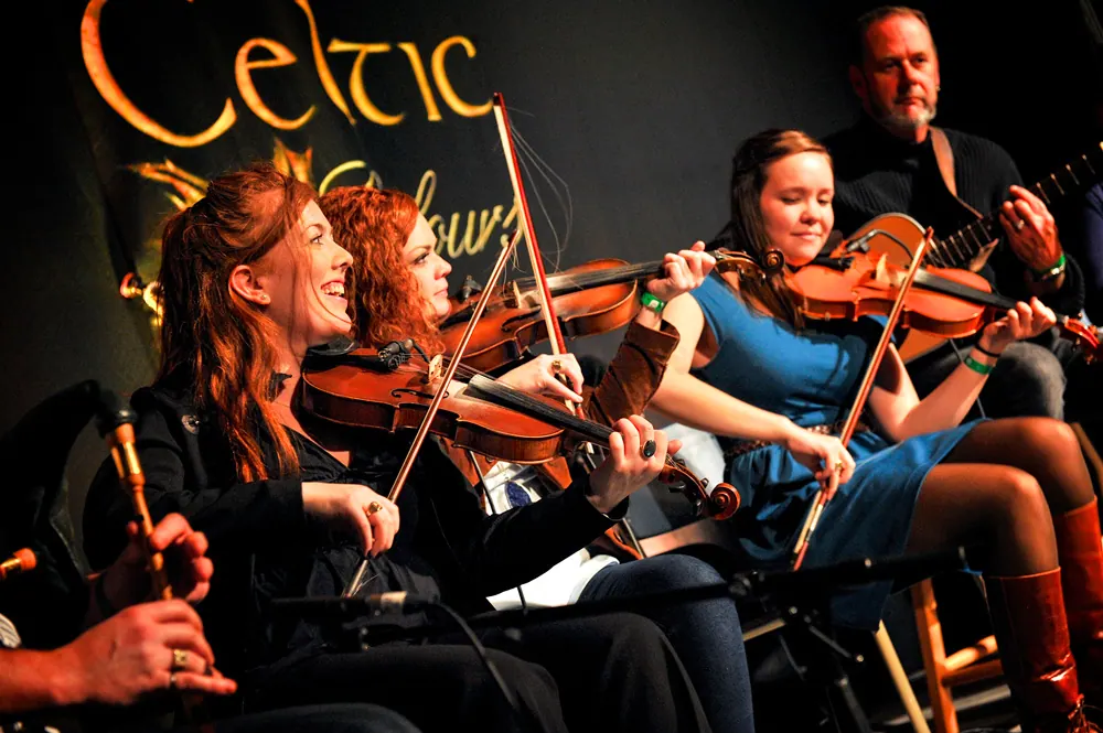 Fiddlers and musicians performing on stage at the Celtic Colours festival
